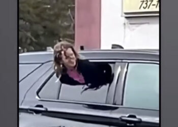 Woman Gets Out Of Tight Spot By Squeezing Through Half-Open Cop Car Window