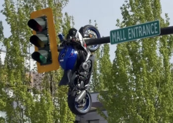 Motorcycle Hangs Out After Crash Launches It On To Street Sign